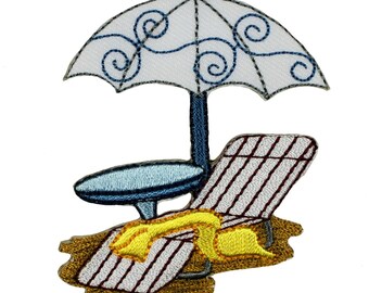 May include: Embroidered patch of a beach scene with a white and blue striped beach chair, a blue and white striped umbrella, and a blue table. The chair has a yellow towel on it and is sitting on a brown patch of sand.