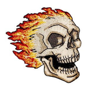 May include: Embroidered patch of a white skull with a toothy grin, engulfed in flames. The flames are a mix of orange, yellow, and red.