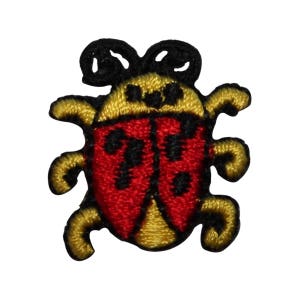 May include: A red and yellow embroidered ladybug with black spots. The ladybug has a yellow body with black eyes and a red shell with black spots. The ladybug is a popular children's theme.