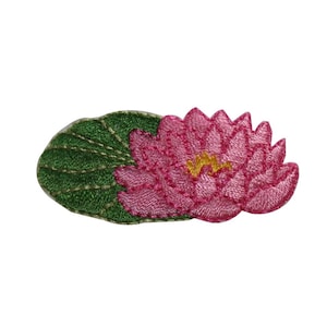 May include: Pink embroidered water lily flower with green leaves. The flower is detailed with yellow accents in the center.