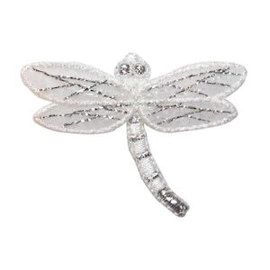 May include: A white and silver dragonfly applique with a glittery finish. The dragonfly has a long, slender body and delicate wings.