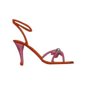 Könnte beinhalten: Orangefarbene und rosafarbene Sandalen mit hohen Absätzen, einem einzigen Riemen um den Knöchel und einer Perle als Dekoration an der Zehe.