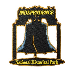 May include: An embroidered patch featuring the Liberty Bell, a symbol of American independence. The patch is black with yellow stitching and the words "Independence National Historical Park" in yellow.