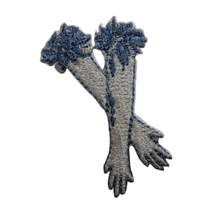 May include: Embroidered iron-on patch featuring two crossed arms with hands, in a light grey colour with blue stitching.