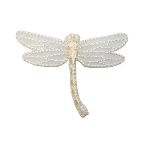 May include: White embroidered dragonfly iron-on patch with a gold outline.