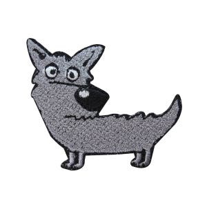 May include: A gray embroidered iron-on patch of a cartoon wolf with a surprised expression. The wolf has a black nose and eyes.