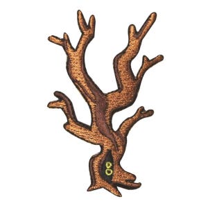 May include: A brown embroidered patch of a stylized tree with two yellow eyes in the trunk.