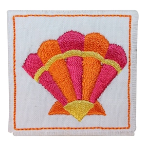 May include: A white fabric square with a pink, orange, and yellow embroidered seashell design.