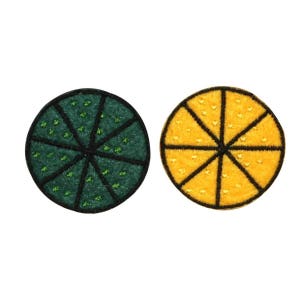May include: Two embroidered felt patches, one green and one yellow, each depicting a circle divided into eight slices.