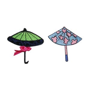 May include: Two embroidered iron-on patches of umbrellas. One is green with a pink bow and the other is blue with pink flowers.