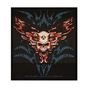 May include: Black embroidered patch with a red and white skull with three eyes and flames. The skull is surrounded by a blue and black tribal design. The text "©2008 ALCHEMY-CARTE LTD. U.K. PAT. PEND." is at the bottom of the patch.