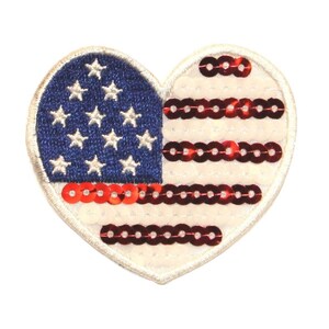 May include: A heart-shaped patch featuring a red, white and blue American flag design. The stars are embroidered and the stripes are made of red sequins.