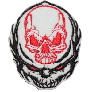 May include: Embroidered patch featuring a black and white skull with red eyes and a red skull outline. The skull is surrounded by a black and white flame design.