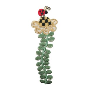May include: A yellow flower with black and white checkered center and a red ladybug on top, with a green stem and leaves.