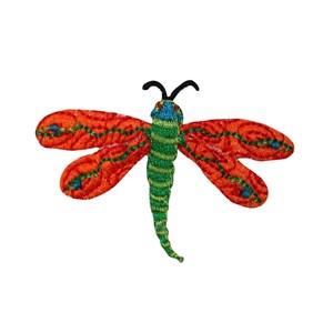 May include: A red, green, and blue embroidered dragonfly applique. The dragonfly has a detailed design with intricate stitching.