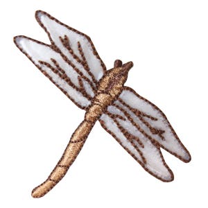 May include: A brown embroidered dragonfly with white wings. The dragonfly is a popular motif for crafts and home decor.