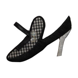 May include: Black and white gingham high heel shoe with a button detail.