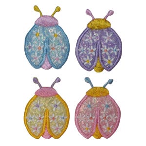 May include: Four embroidered iron-on patches of ladybugs with floral designs. The ladybugs are in shades of pink, yellow, blue, and purple.