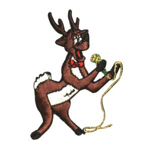 May include: A brown reindeer with a red bow tie is holding a microphone and singing. The reindeer is wearing a white shirt and has a gold rope attached to its leg.