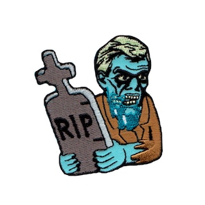 May include: An embroidered patch featuring a blue zombie holding a tombstone with the inscription "RIP". The zombie has a brown jacket and a blue beard.