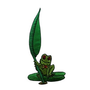 May include: Green frog with red eyes and a red bow tie sitting on a green lily pad with a green leaf behind it.