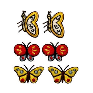 May include: Six embroidered iron-on patches featuring butterflies in various colors and designs. The patches include yellow, red, and blue butterflies.