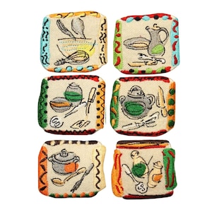May include: Six embroidered fabric squares with different kitchen utensils and cookware designs. Each square has a white background with colorful borders and a different design, including a bowl, whisk, spoon, pot, teapot, and a pitcher.