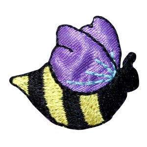 May include: A purple and black embroidered bee patch with yellow stripes. The bee has a purple body and black wings.