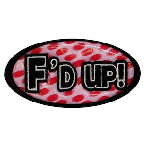 May include: An oval-shaped patch with a red and white polka dot background. The patch has black lettering that reads "F'd Up!" with a white outline.