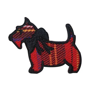 May include: Embroidered patch in the shape of a Scottish Terrier dog. The dog has a black head and tail, with a red and black plaid body. Yellow and blue accents are visible in the plaid pattern. The patch is likely for clothing or accessories.
