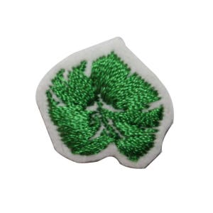 May include: Green embroidered leaf patch on a white background.