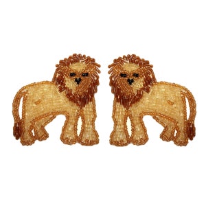 May include: A pair of beaded lion earrings. The lions are made of brown and gold beads and have black eyes.