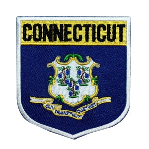 May include: A blue and white embroidered patch with the words "CONNECTICUT" in black letters on a yellow background. The patch features the state seal of Connecticut, which includes a white shield with a green tree and three blue grapes on each side. The motto "QUI TRANSTULIT SUSTINET" is written on a white ribbon below the shield.