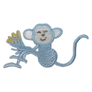 May include: A blue embroidered monkey holding a yellow banana. The monkey has a white face with a smiling expression.