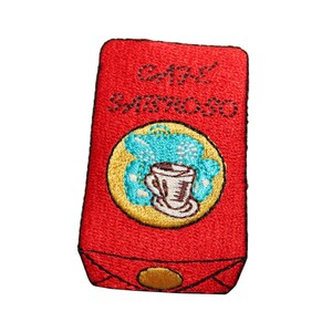 May include: Red embroidered patch with the text "Cafe Santoro" and a yellow circle with a blue and white coffee cup inside.