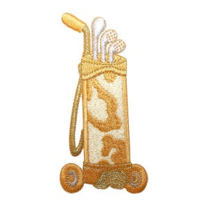 Könnte beinhalten: Eine goldene und weiße Golftasche mit einem braunen Riemen und Rädern. Die Tasche hat ein Muster aus kleinen goldenen Kreisen. Aus der Oberseite der Tasche ragen drei Golfschläger heraus.