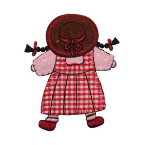 May include: Red and white gingham dress with a pink bodice and a red hat. The doll has black hair in pigtails.