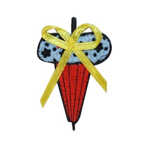 May include: A red and blue ice cream cone with a yellow bow. The ice cream cone is decorated with black dots and a video game controller design.