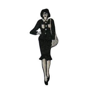 May include: Black and white embroidered iron-on patch of a woman wearing a suit and carrying a purse.