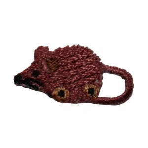 May include: A small, brown embroidered patch of a mouse. The mouse is facing left and has a long tail that curves around to the right.