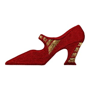 May include: Red embroidered shoe with a gold pointed toe and heel. The shoe has a pointed toe and a high heel.