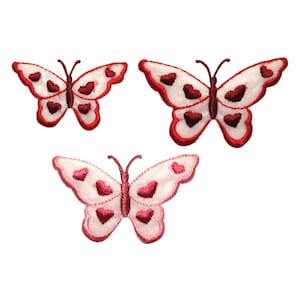 May include: Three embroidered iron-on patches in the shape of butterflies with red and white hearts.