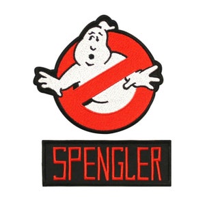 May include: Two embroidered patches, one featuring the Ghostbusters logo with a red circle and a white ghost, and the other with the word "SPENGLER" in red lettering on a black background.