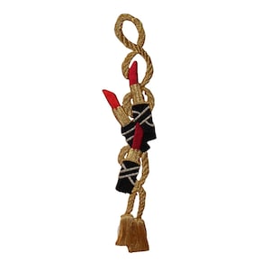 May include: Gold rope charm with a tassel and three red and black lipstick charms.