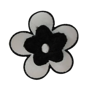May include: A white flower with a black center. The flower has five petals and is outlined in black.