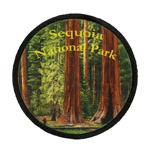 May include: A round, black-bordered patch with a photo of tall redwood trees in Sequoia National Park. The text "Sequoia National Park" is printed in yellow on the patch.