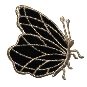 May include: Black velvet butterfly applique with silver thread embroidery. The butterfly has a detailed wing pattern and a pair of antennae.