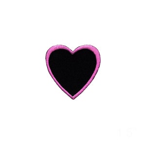 May include: A pink heart-shaped patch with a black center.