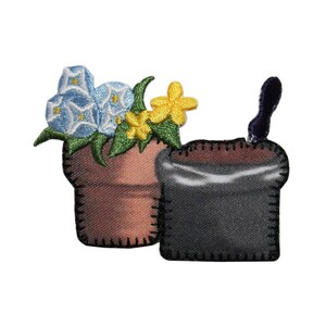 May include: Two embroidered fabric flower pots. One pot is brown with blue and yellow flowers. The other pot is black and has a brown top.