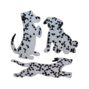 May include: Three white and black dalmatian dog silhouette iron-on patches. The patches are in different poses, one standing, one sitting, and one running.